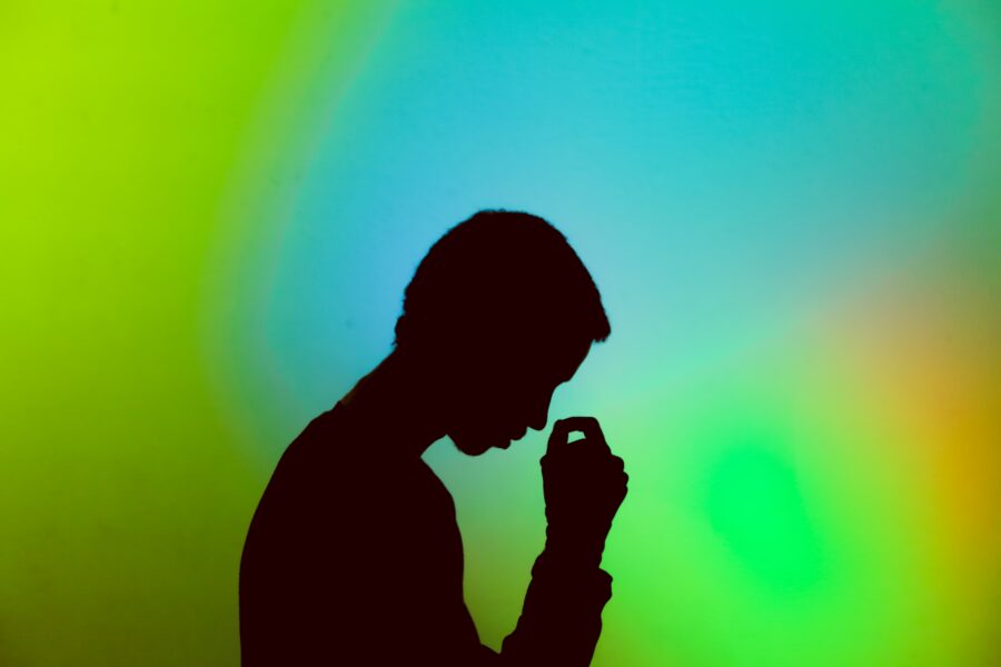 Women stressed in front of coloured background