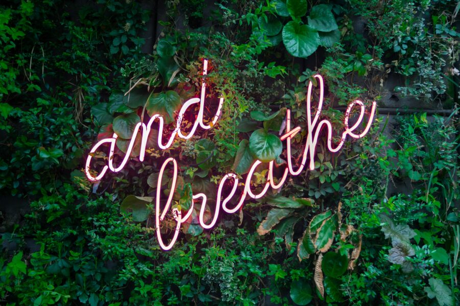 Neon 'and breathe' sign